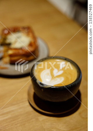 Cup of hot milk piccolo latte coffee on table. Cup of hot milk piccolo latte coffee on table. 138527469