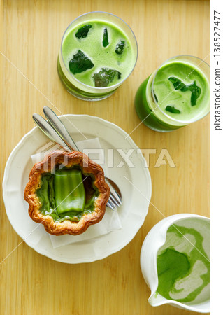 Cup of fresh matcha tea, green tea and Portuguese sweet dessert egg tart or Pastel de Nata, decorated as Thailand style dessert. 138527477