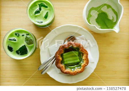 Cup of fresh matcha tea, green tea and Portuguese sweet dessert egg tart or Pastel de Nata, decorated as Thailand style dessert. 138527478
