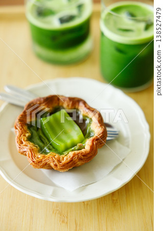 Cup of fresh matcha tea, green tea and Portuguese sweet dessert egg tart or Pastel de Nata, decorated as Thailand style dessert. Cup of fresh matcha tea, green tea and Portuguese sweet dessert egg tart or Pastel de Nata, decorated as Thailand style dessert. 138527479