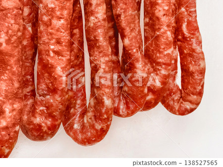 Drying sausages raw minced meat white wall background home Drying sausages raw minced meat white wall background home 138527565