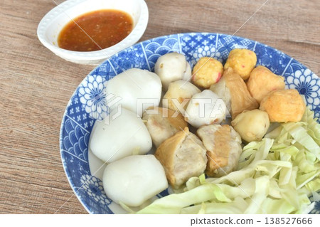 steamed fish and shrimp meatball with chop cabbage on plate dipping Thai spicy chili seafood sauce 138527666