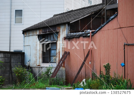 An old, single-story house with striking rusty corrugated iron walls. An old, single-story house with striking rusty corrugated iron walls. 138527675
