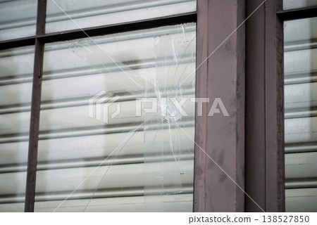 Old window glass that was broken and repaired with tape 138527850