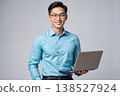 Asian man in blue shirt holding laptop with copy space for design and technology concepts 138527924