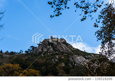 Sintra Moorish Castle atop a rocky hill under a clear blue sky 138528200