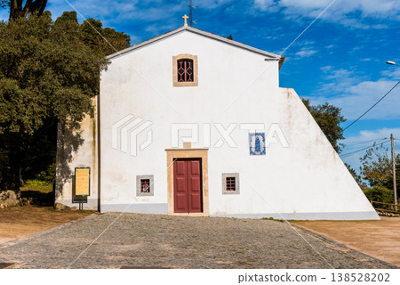 The Chapel of Peninha in Sintra, Portugal, under a bright blue sky. The Chapel of Peninha in Sintra, Portugal, under a bright blue sky. 138528202