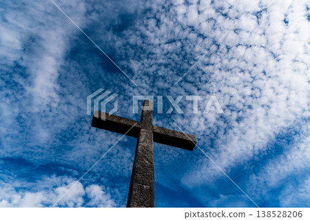 Stone Cross Against Blue Sky 138528206