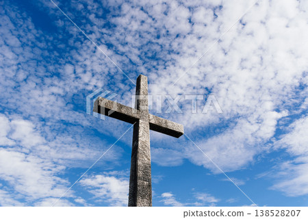 Stone Cross Against Blue Sky 138528207