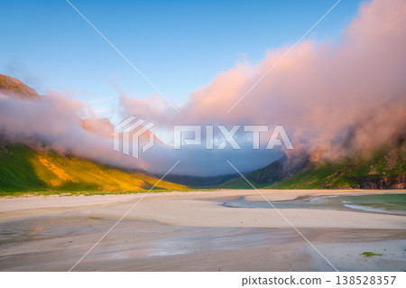 Norwegian arctic landscape with mountains, ocean, and blue sky. Norwegian arctic landscape with mountains, ocean, and blue sky. 138528357