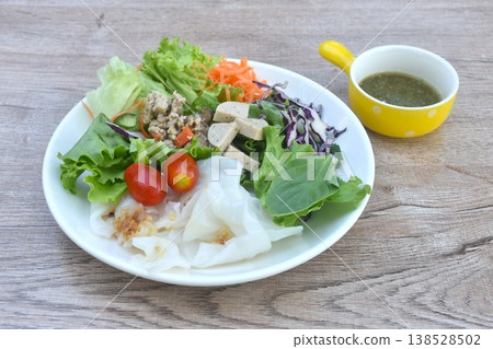 dry large rice noodles with boiled chop pork and slice Vietnamese sausage with mixed vegetable salad on plate dressing spicy chili sauce dry large rice noodles with boiled chop pork and slice Vietnamese sausage with mixed vegetable salad on plate dressing spicy chili sauce 138528502