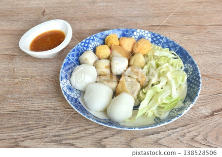 steamed fish and shrimp meatball with chop cabbage on plate dipping Thai spicy chili seafood sauce 138528506