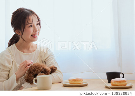 A woman's café time spent with her toy poodle: A life filled with coffee and sweets. A woman's café time spent with her toy poodle: A life filled with coffee and sweets. 138528934