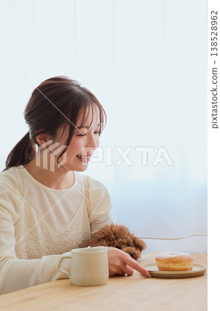 A woman's café time spent with her toy poodle: A life filled with coffee and sweets. A woman's café time spent with her toy poodle: A life filled with coffee and sweets. 138528962