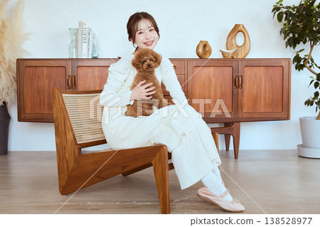 A woman and her toy poodle: A natural lifestyle with her pet. 138528977