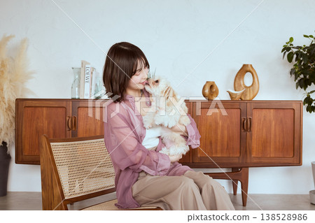 A woman holding a Maltese dog: A natural life with pets A woman holding a Maltese dog: A natural life with pets 138528986