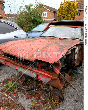 A rusted vintage car being abandoned on a street with flat tires and rusty bodywork A rusted vintage car being abandoned on a street with flat tires and rusty bodywork 138529672
