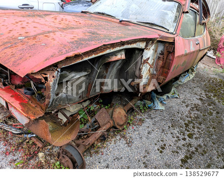 A rusted vintage car being abandoned on a street with flat tires and rusty bodywork A rusted vintage car being abandoned on a street with flat tires and rusty bodywork 138529677