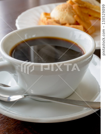 Coffee and waffles: A sweet treat to enjoy at a cafe. Coffee and waffles: A sweet treat to enjoy at a cafe. 138529899