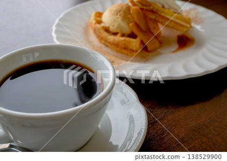 Coffee and waffles: A sweet treat to enjoy at a cafe. Coffee and waffles: A sweet treat to enjoy at a cafe. 138529900