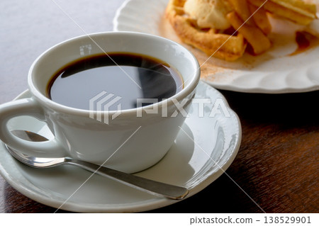 Coffee and waffles: A sweet treat to enjoy at a cafe. Coffee and waffles: A sweet treat to enjoy at a cafe. 138529901