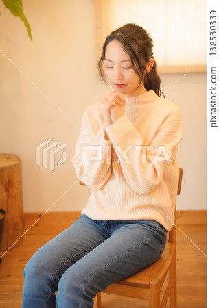 Daughter prays for the deceased at home. Daughter prays for the deceased at home. 138530339