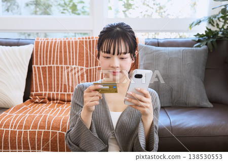 Woman making online payment with smartphone 138530553