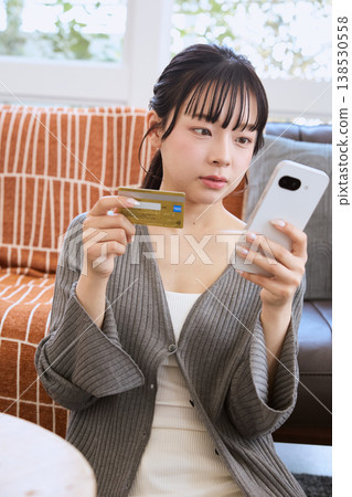 Woman making online payment with smartphone 138530558
