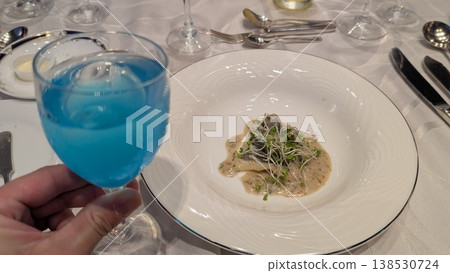 A set menu featuring blue drinks and fish dishes. 138530724