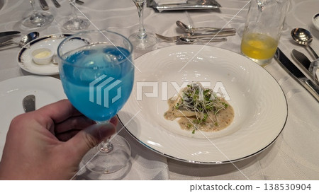 A set menu featuring blue drinks and fish dishes. 138530904