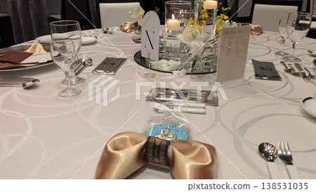 Wedding reception table setting and floral arrangements 138531035