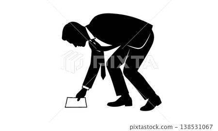 Silhouette of a businessman picking something up Silhouette of a businessman picking something up 138531067
