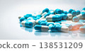Selective focus on blue and white capsules pill spread on white background with shadow. Global healthcare concept. Antibiotics drug resistance. Antimicrobial capsule pills. Pharmaceutical industry. 138531209