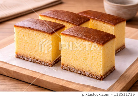 Traditional Japanese castella cake served on a wooden plate with coarse sugar. 138531739