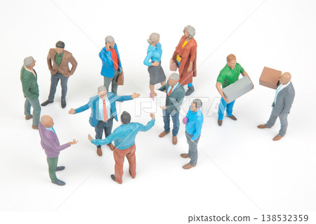 Miniature people gather in a social setting for discussion and interaction in a casual environment 138532359