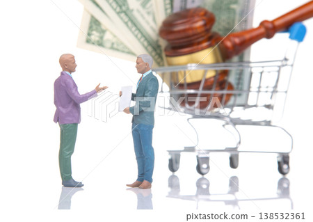 Miniature people discussing legal matters with money and a shopping cart in the background  138532361