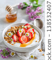 bowl of yogurt with strawberries, granola and honey, generative ai 138532407