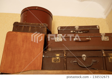 Close up of old vintage suitcases and a round hat box from the last century. Worn leather texture 138532673