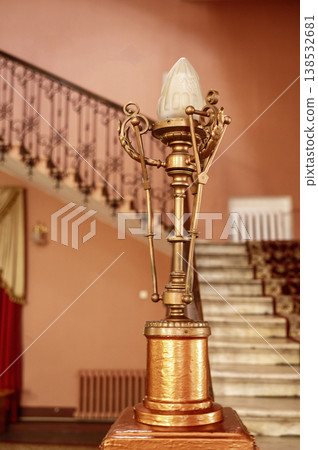 Copper-colored Art Nouveau style lamp decor in an old building entrance. Copper-colored Art Nouveau style lamp decor in an old building entrance. 138532681