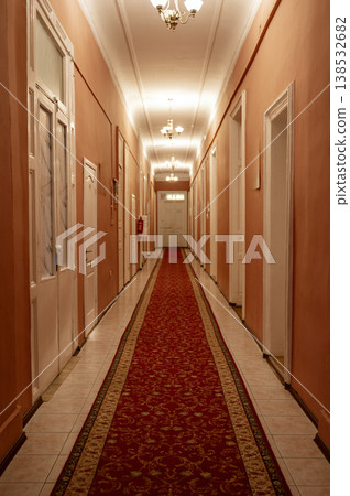 Perspective view of a grand hotel hallway with a red carpet. Classic interior design Perspective view of a grand hotel hallway with a red carpet. Classic interior design 138532682