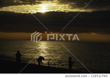 Golden sunset over calm sea with dramatic clouds and sun rays breaking through sky, warm orange horizon, tranquil ocean surface, atmospheric seascape, natural light, serene evening landscape Golden sunset over calm sea with dramatic clouds and sun rays breaking through sky, warm orange horizon, tranquil ocean surface, atmospheric seascape, natural light, serene evening landscape 138532769