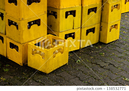 Stacked yellow plastic crates with glass bottles, industrial storage and beverage distribution concept, reusable containers for logistics and recycling, warehouse supply background Stacked yellow plastic crates with glass bottles, industrial storage and beverage distribution concept, reusable containers for logistics and recycling, warehouse supply background 138532771
