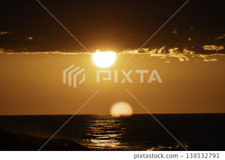 Bright sun over sea horizon with intense orange sky and reflection on water, dramatic sunset with glowing light and clouds, minimal seascape background, warm tones and natural atmospheric landscape Bright sun over sea horizon with intense orange sky and reflection on water, dramatic sunset with glowing light and clouds, minimal seascape background, warm tones and natural atmospheric landscape 138532791