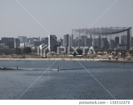 The sandy beach of Omori Furusato Beach Park and the cityscape stretching out on the opposite shore. The sandy beach of Omori Furusato Beach Park and the cityscape stretching out on the opposite shore. 138532878