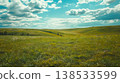 Vast Prairie Landscape with Rolling Hills and Majestic Clouds. Concept of Tranquility, Natural Beauty, Countryside Peacefulness, and Open Spaces 138533599