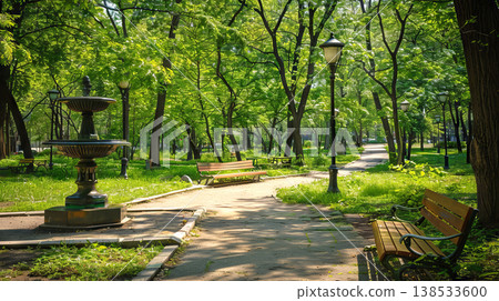 Tranquil City Park Scene with Fountain and Benches Amid Lush Greenery. Concept of Urban Oasis, Nature, Serene Retreat, and Outdoor Relaxation Tranquil City Park Scene with Fountain and Benches Amid Lush Greenery. Concept of Urban Oasis, Nature, Serene Retreat, and Outdoor Relaxation 138533600