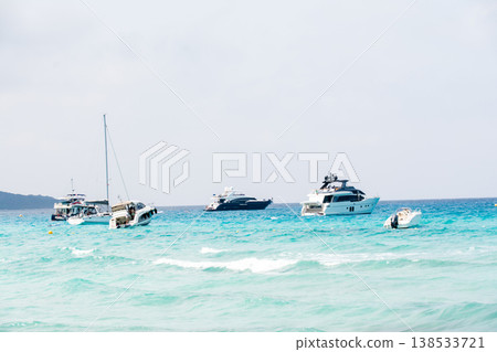 A leisure boat floats on the beautiful emerald green sea at Corsica, a French territory in the Mediterranean Sea. 138533721