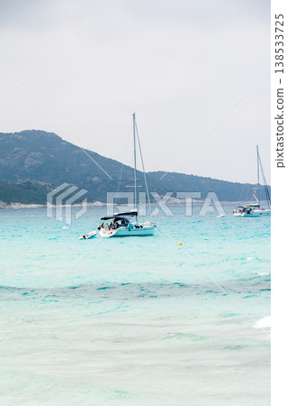 A leisure boat floats on the beautiful emerald green sea at Corsica, a French territory in the Mediterranean Sea. 138533725