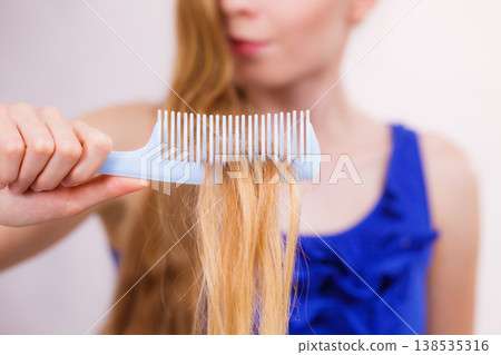 Blonde woman with her damaged dry hair. 138535316