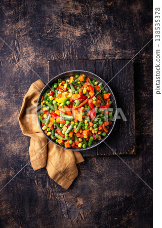Frozen mix of vegetables on dark background Frozen mix of vegetables on dark background 138535378